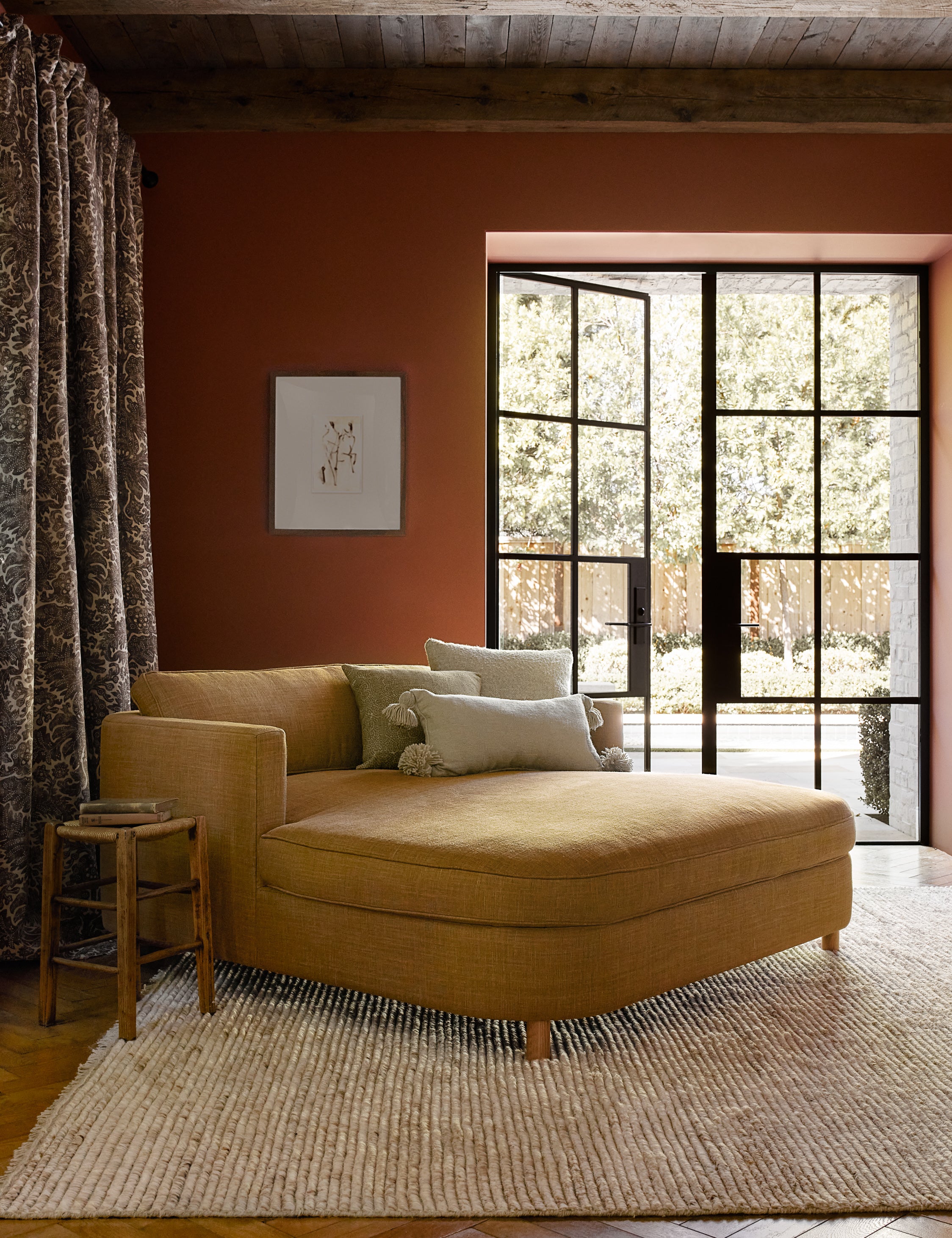 Same chaise lounge in light cream/beige fabric with wide curved seat and short wooden legs.