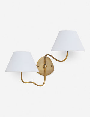 Magdalene brass double sconce with a white linen shade, a round wall mount, and an arched arm