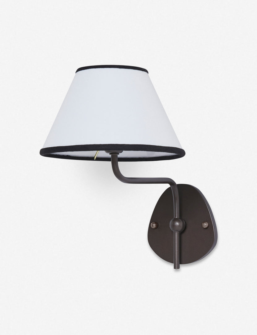 #color::black-trim #finish::bronze | Magdalene black single sconce with a white linen shade that has a black trim, a round wall mount, and an arched arm