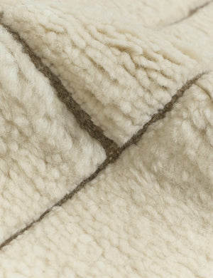 Close-up of the tufting on the Maleena cream hand-knotted wool and cotton area rug with abstract line tufting