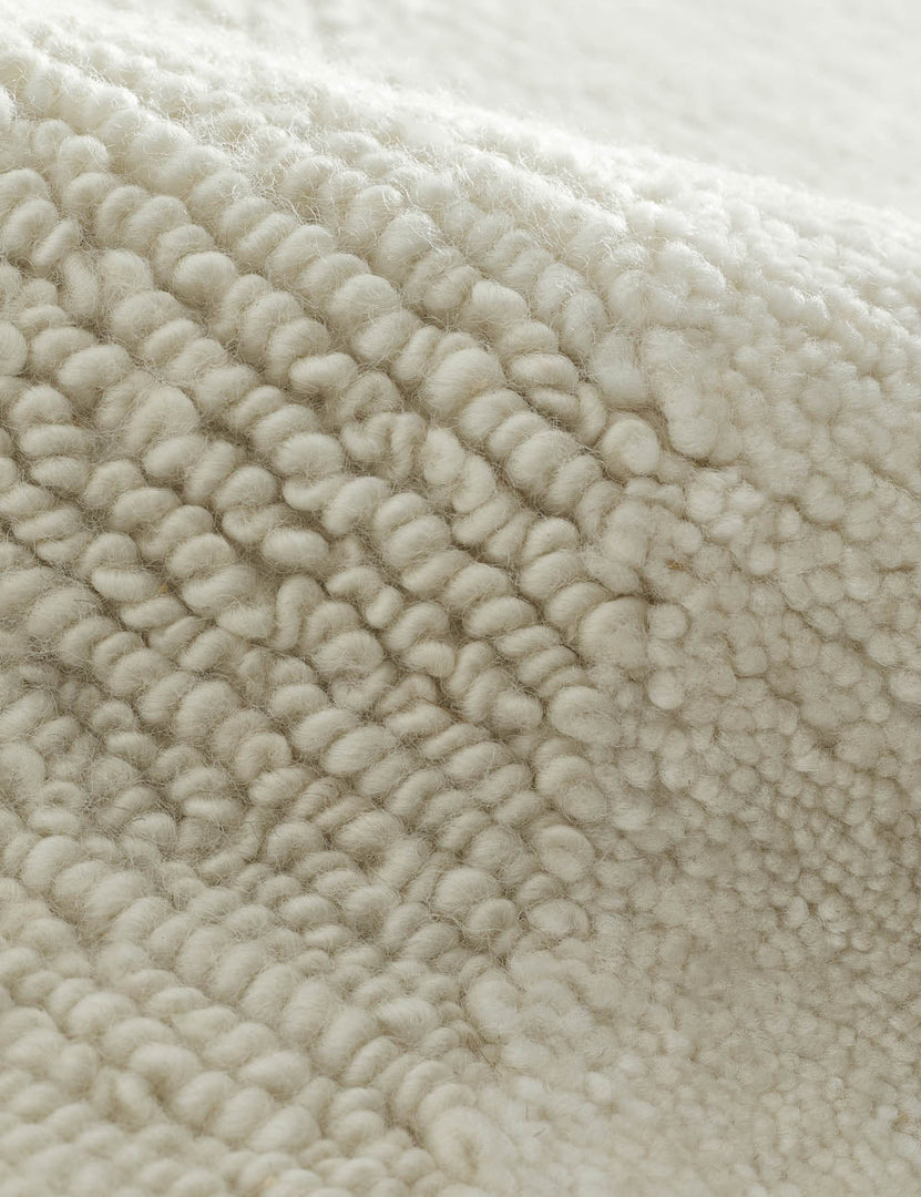 #size::6--x-9- #size::8--x-10- #size::9--x-12- #size::10--x-14- #size::12--x-15- | Close-up of the wool blend fabric on the Malin hand-knotted ivory Rug 