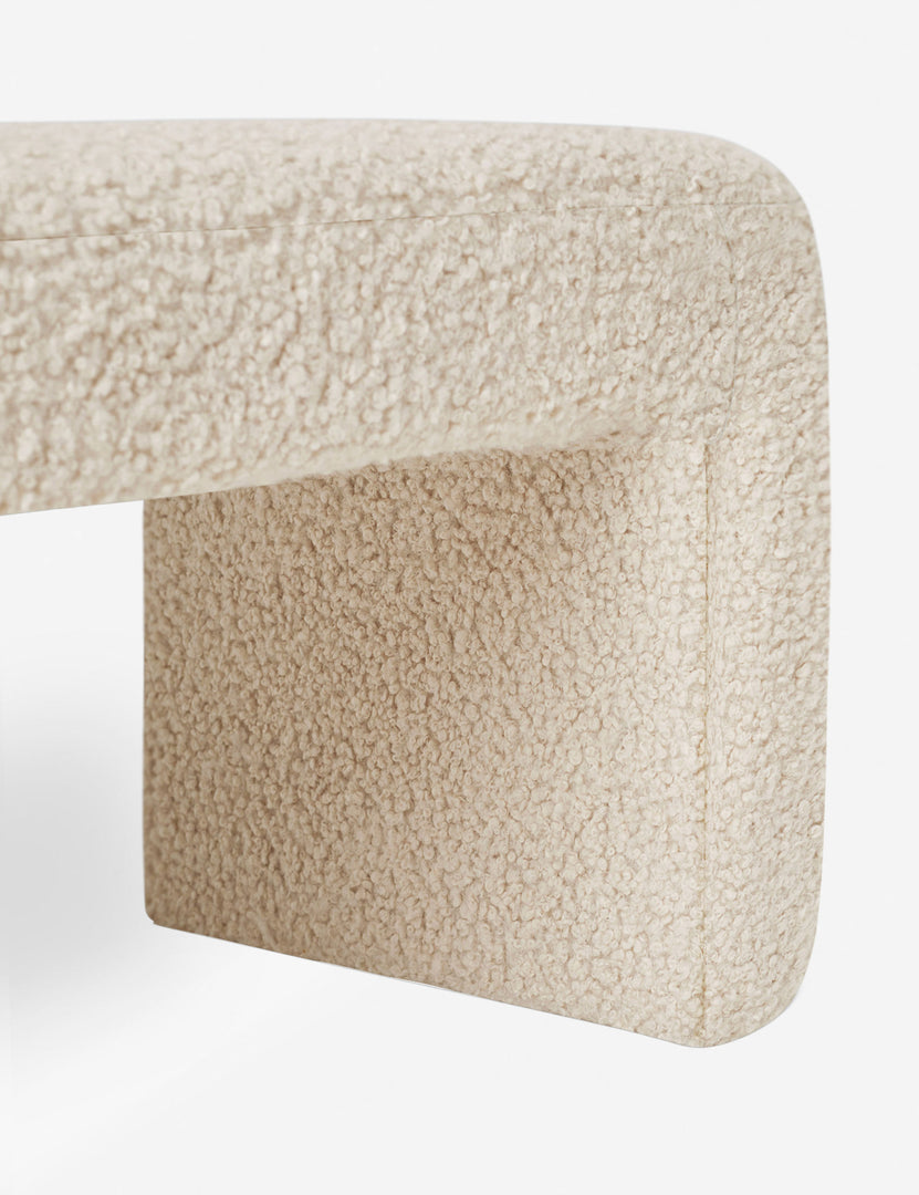 #color::cream-boucle | Close-up of the side and inner wall of the Mikhail cream boucle foam-padded bench.