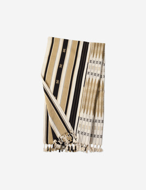 Sita black, natural, and ivory throw blanket that is loin-loomed with indigenous motifs and fringe at the ends