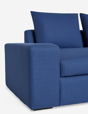 Close up of the low and wide arm on the Nadine blue performance fabric sofa