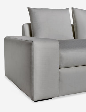 Close up of the low and wide arm and tall cushions on the Nadine gray performance fabric sofa