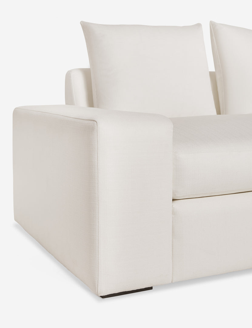 #color::ivory-linen #size::108-W #size::96-W #size::84-W | Close up of the low and wide arm and tall cushions on the Nadine ivory linen sofa