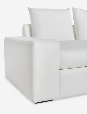 Close up of the low and wide arm and tall cushions on the Nadine white performance fabric sofa