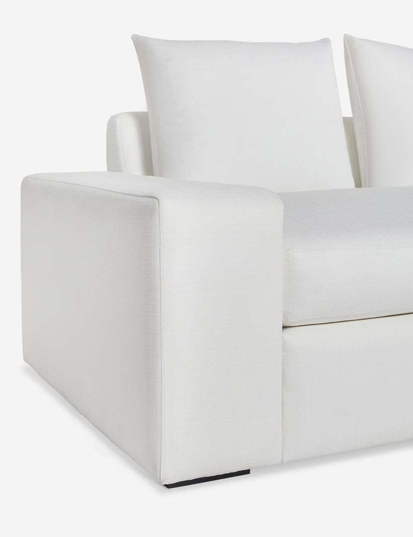 #color::white-performance-fabric #size::108-W #size::96-W #size::84-W | Close up of the low and wide arm and tall cushions on the Nadine white performance fabric sofa