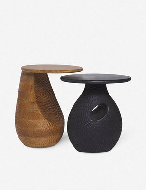 The Gem mango wood side table is nested over a black side table with a similar design