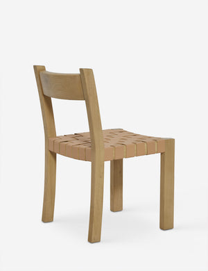 Angled rear view of the Vix light wood frame and woven leather seat dining chair.