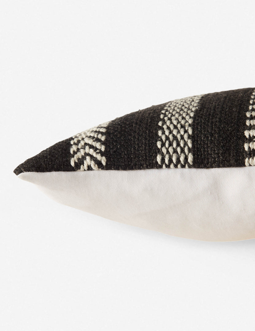 #color::black | Close up side view of the kamala indoor and outdoor lumbar throw pillow with bohemian accents in black