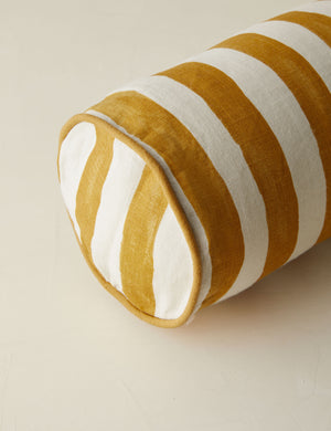 Close up of the Painterly stripe linen long bolster throw pillow in goldenrod and ivory
