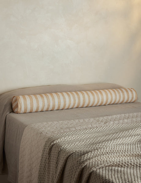 #color::natural-and-ivory | Painterly stripe linen long bolster throw pillow in natural and ivory styled on a bed