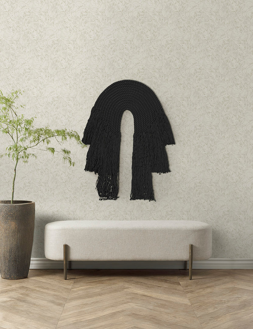 #color::black | The black forte wall hanging hangs on an ivory wall above a white linen bench