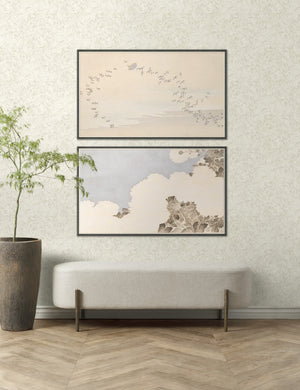 Summer skies wall art set of 2, the first image featuring a flock of birds and the second featuring a botanical canopy are hung above a linen bench