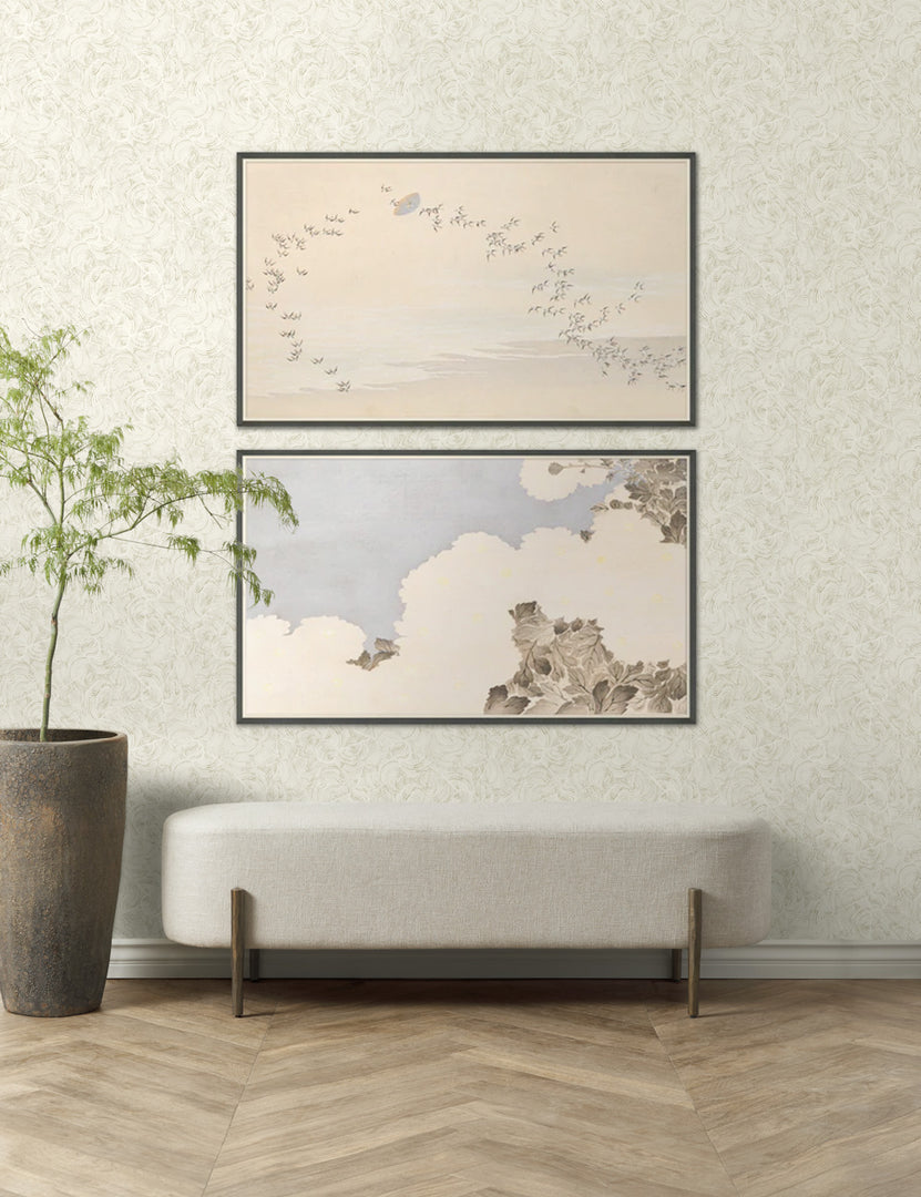 | Summer skies wall art set of 2, the first image featuring a flock of birds and the second featuring a botanical canopy are hung above a linen bench