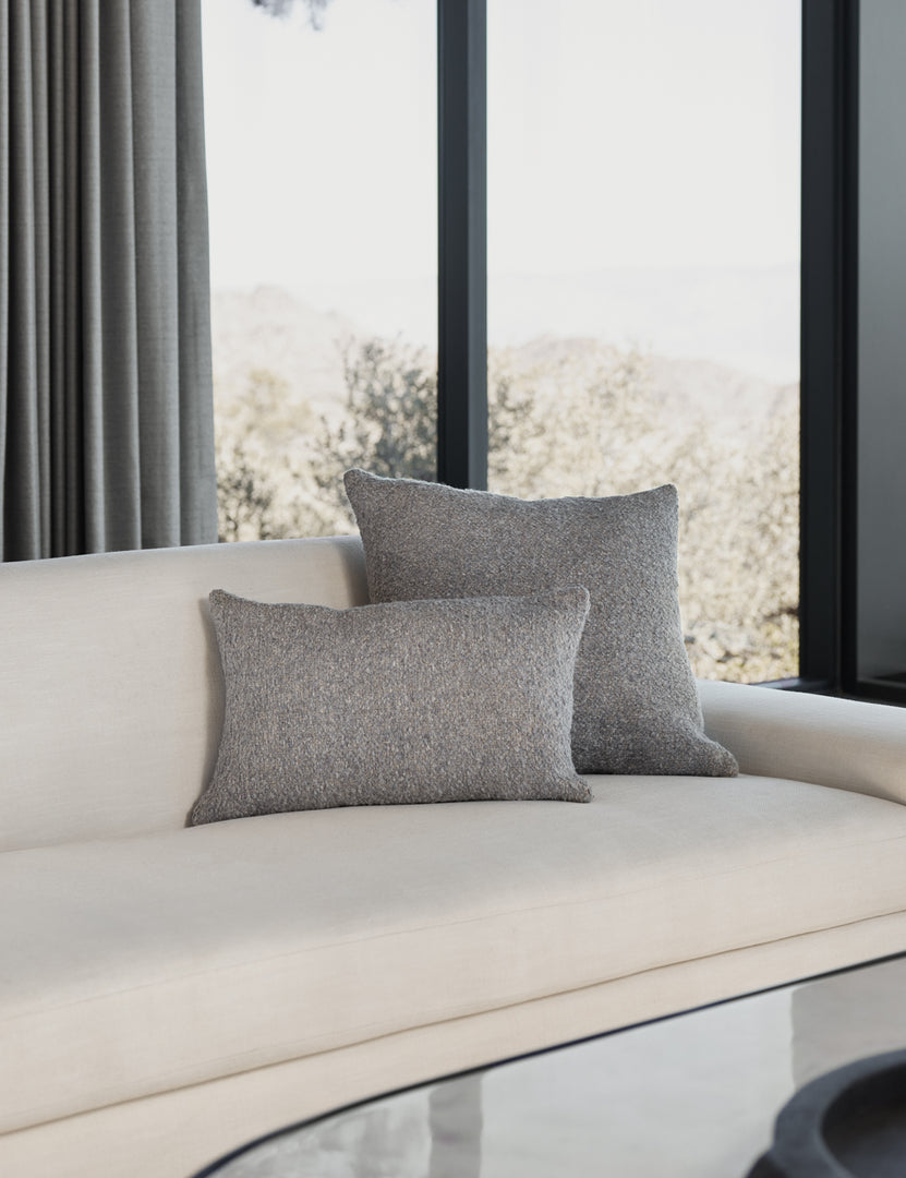 #color::slate #size::13--x-20- | The manon linen slate gray boucle pillow in both sizes lay on a white linen sofa in a living room with an oval coffee table