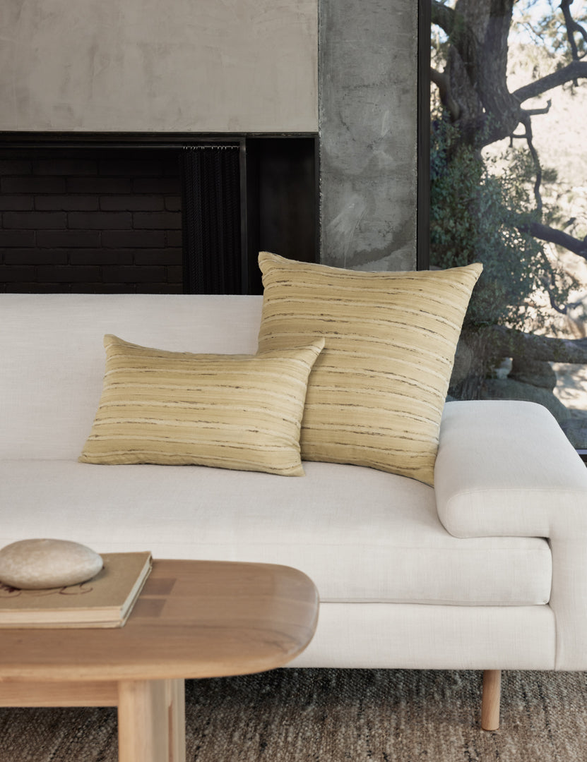 #size::12--x-20- #size::20--x-20- | The leni silk pillow in both sizes sit together on a white linen sofa next to a wooden coffee table