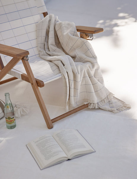 #color::pop-check #style::pop-check | Pop check Beach Towel by Business & Pleasure Co hangs on a beach chair next to a book