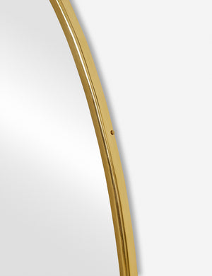 The gold curved frame on the large puddle mirror