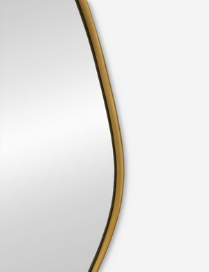 The gold curved frame on the small puddle mirror