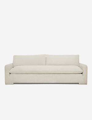 Rupert Ivory Boucle sofa with an elevated frame and plush cushions by Sarah Sherman Samuel