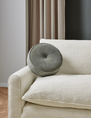 Velvet Disc juniper green Pillow by Sarah Sherman Samuel sits on a linen sofa