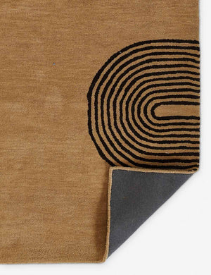 The corner of the Laci natural rug folded over