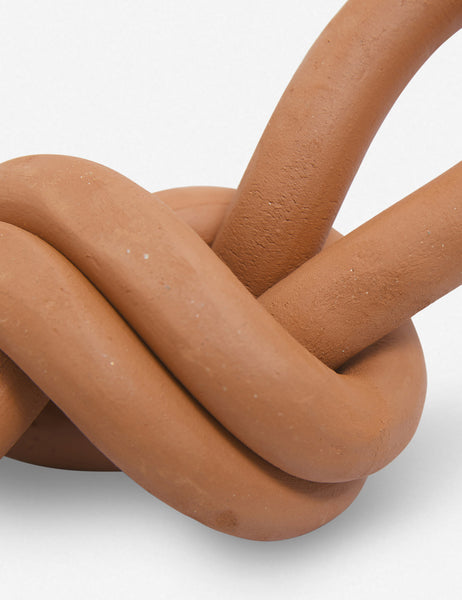 #color::terracotta | Close up of the Overhand terracotta ceramic Knot decorative object by SIN
