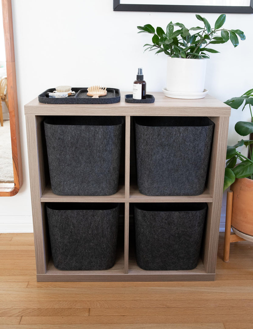 #color::carbon | Four of The Sculpted Bin in carbon black (Set of 3) by SortJoy sit in a wooden shelf 