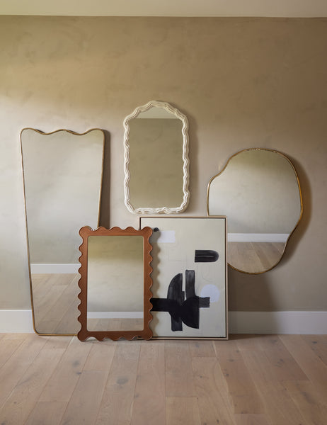 | The anastasia mirror hangs on the wall of a studio room with other Sarah Sherman Samuel mirrors