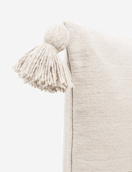 #color::natural #size::20--x-20-  | Close-up of the pom pom on the corner of the Sami natural square pillow