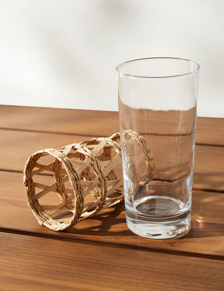 | One Shelly Iced Tea glass with its woven seagrass sleeve removed sitting next to it