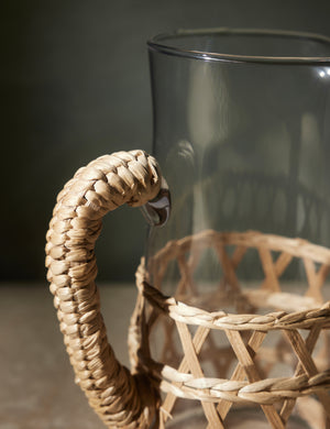 Close-up of the woven wrapped handle on the Shelly glass pitcher with natural seagrass accent