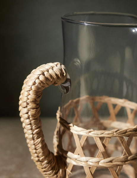 | Close-up of the woven wrapped handle on the Shelly glass pitcher with natural seagrass accent