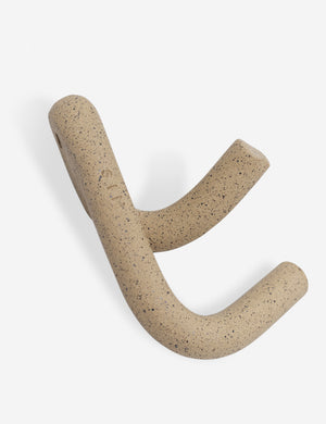Angled view of the Cream speckled Leggy Crossed Wall Hook by SIN Ceramics