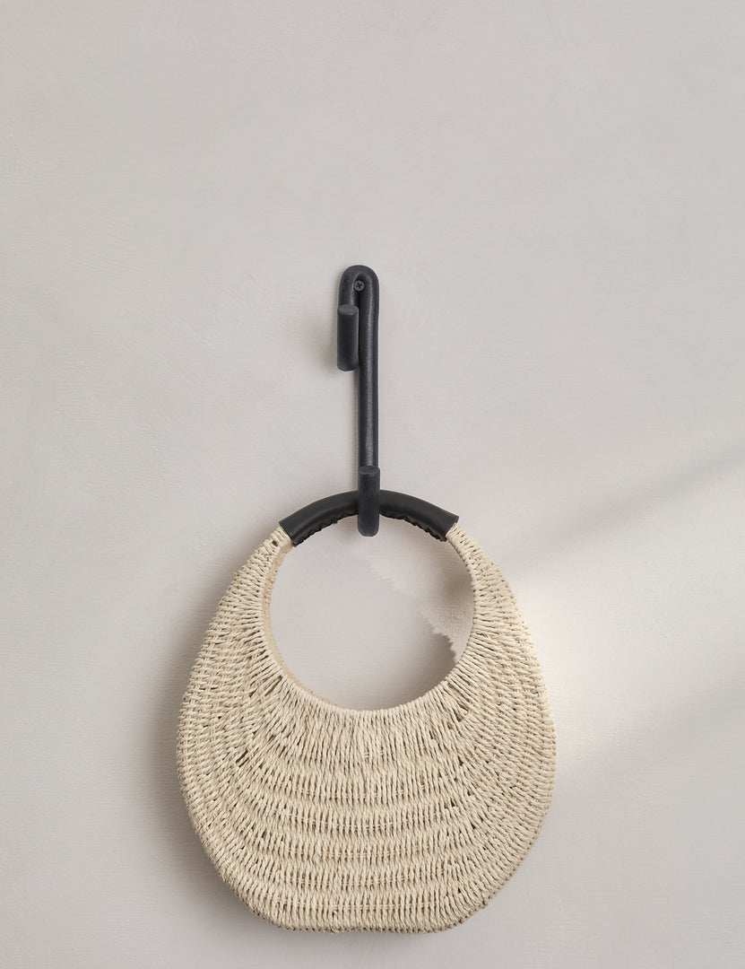 #color::black | Black Leggy Long Wall Hook by SIN Ceramics with a rattan bag hanging on it