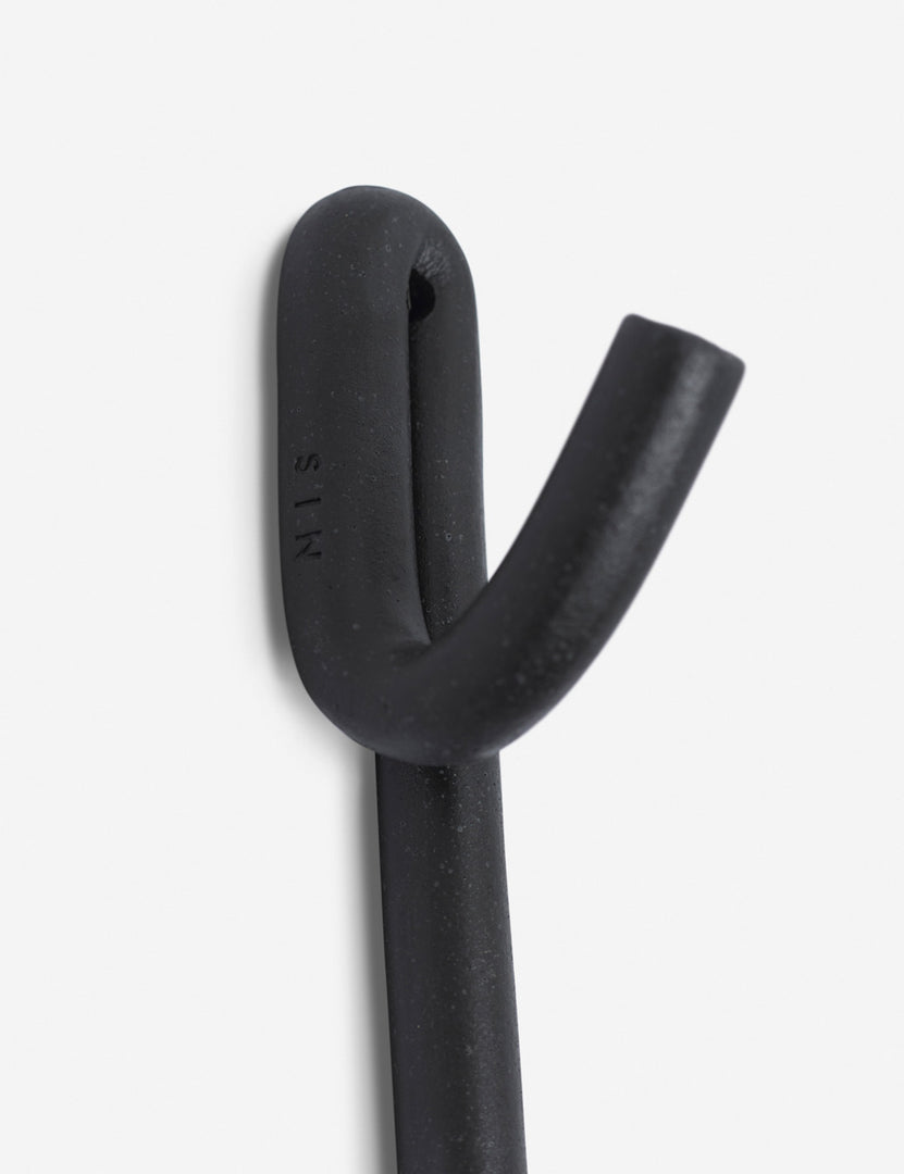 #color::black | Close-up of the first hook on the Black Leggy Long Wall Hook by SIN Ceramics