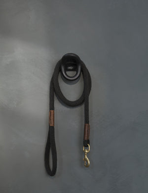 The olo black wall hook with a black leash hanging from it