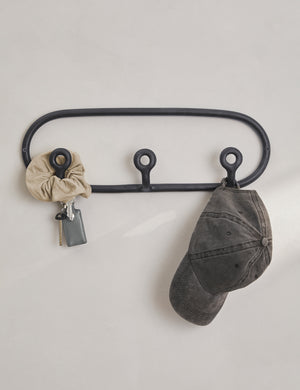 Black Trio Stoneware Coat Rack by SIN Ceramics with a scrunchie, keys, and hat hanging from it