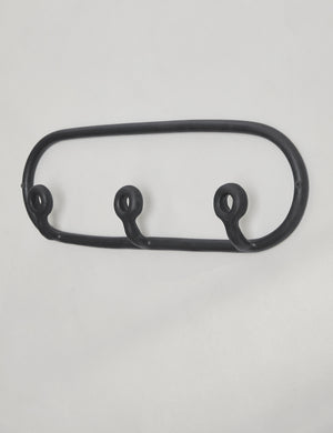 Angled view of the Black Trio Stoneware Coat Rack by SIN Ceramics
