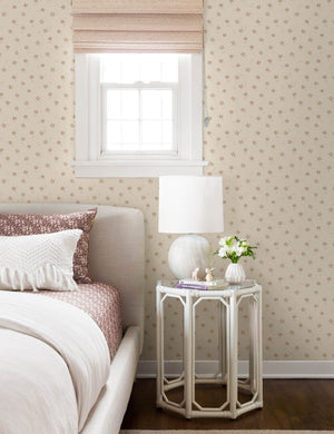The starfish wallpaper is in a bedroom with natural framed bed next to a hexagonal white nightstand
