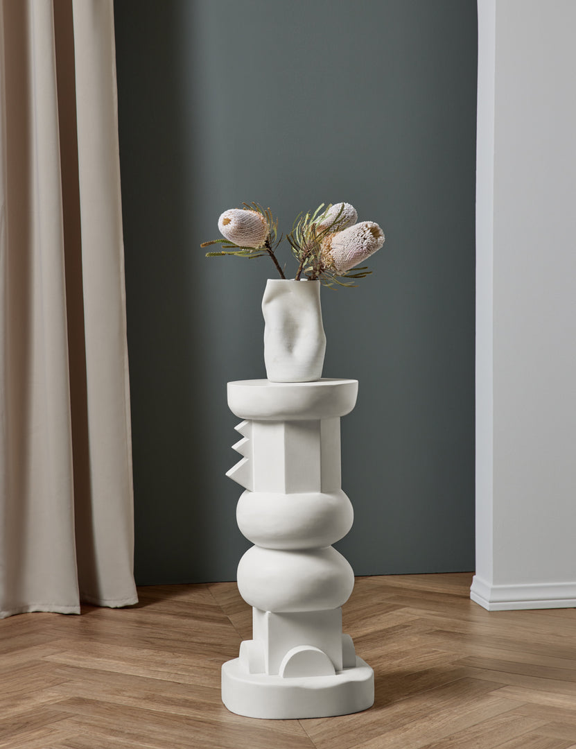 #size::short | The Toivo short pedestal stands in a room with a sculptural vase sitting atop it