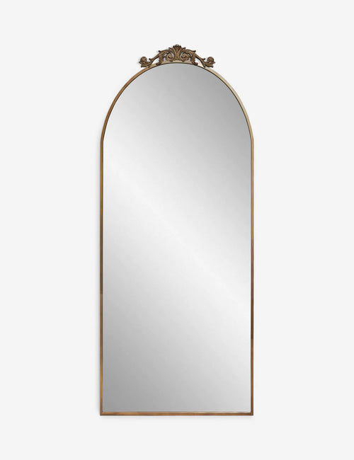 | Tulca narrow brass floor mirror with a flat bottom edge and traditional scroll detailing