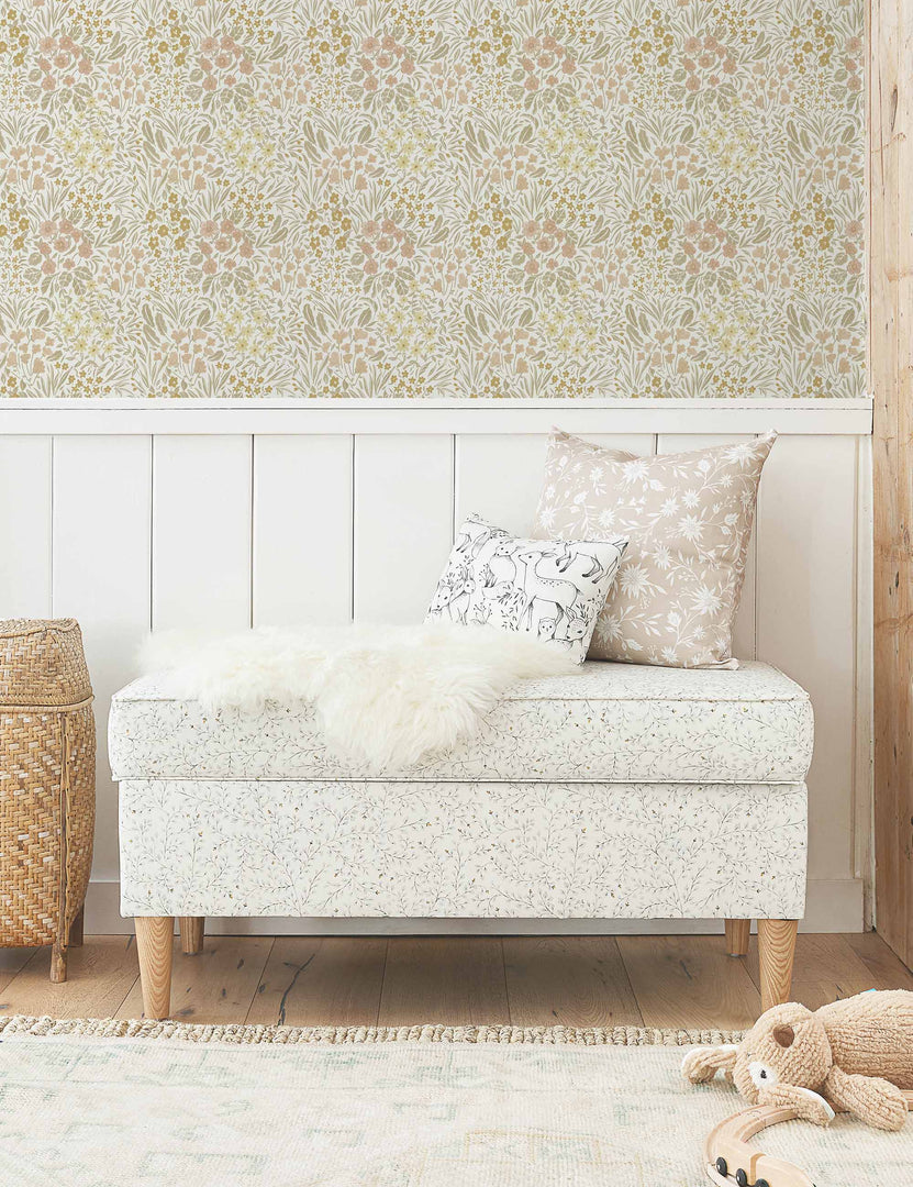 #color::warm | Warm-toned Floral Field Wallpaper by Rylee + Cru is in a nursery with wooden accented walls and a floral cushioned bench