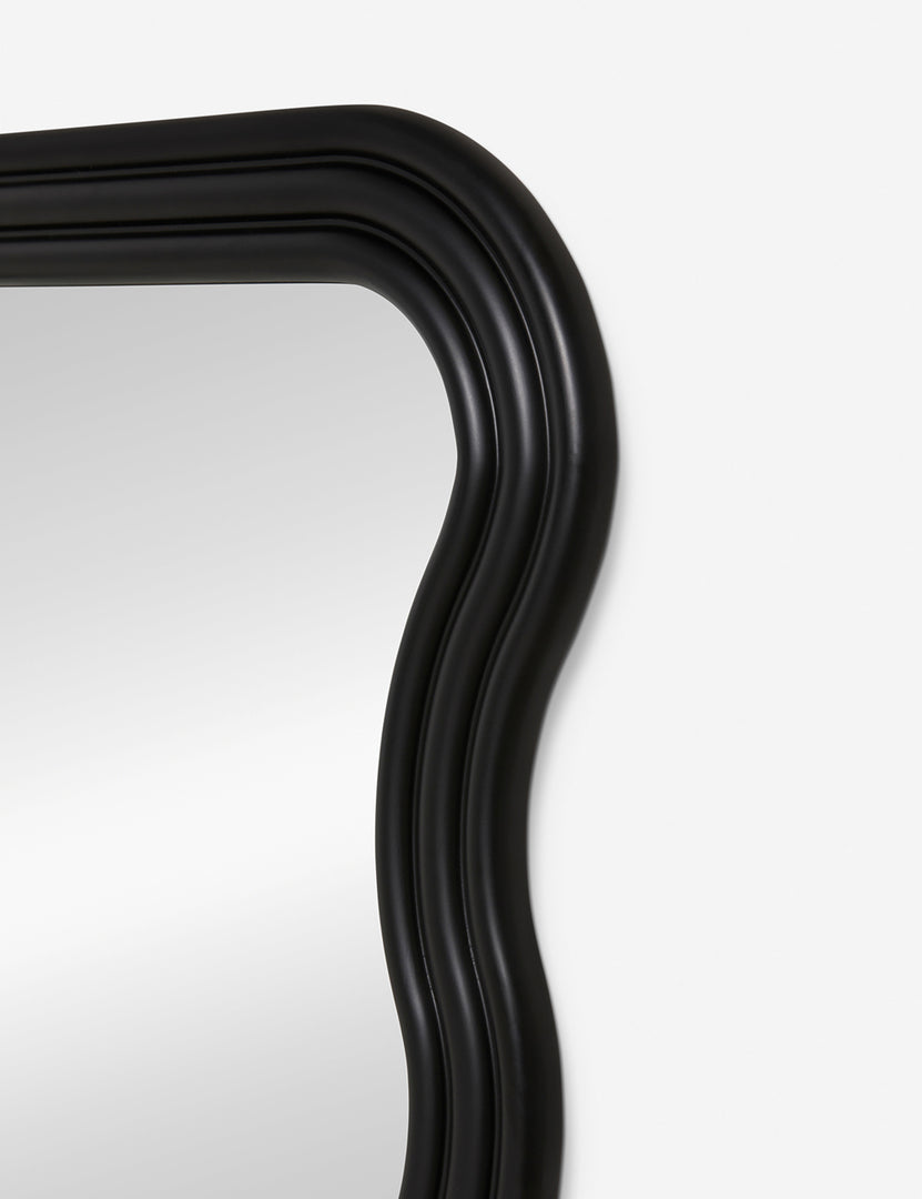 #size::large #size::small | Close-up of the right corner of the Wendolyn wavy thick-framed black wall mirror. | Upper corner of the Wendolyn Mirror