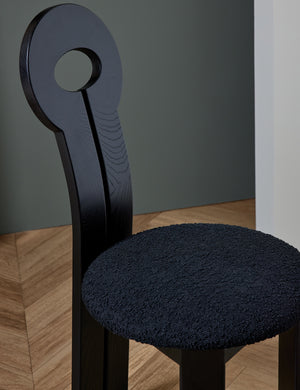 Close-up of the backrest and black cushioning on the Whit black wood sculptural dining chair by sarah sherman samuel