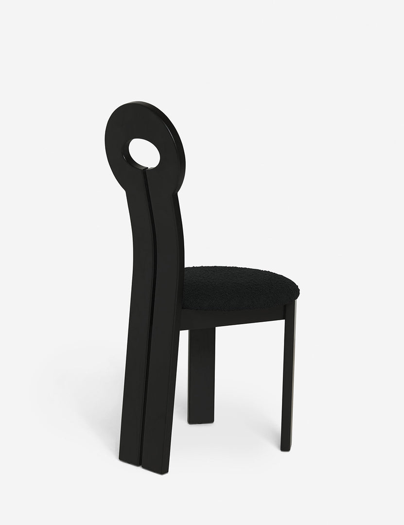 #color::black | Angled rear view of the Whit black wood sculptural dining chair by sarah sherman samuel