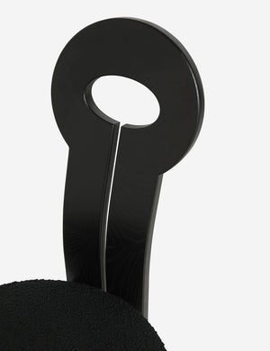 Close-up of the eyelet-style back on the Whit black wood sculptural dining chair by sarah sherman samuel