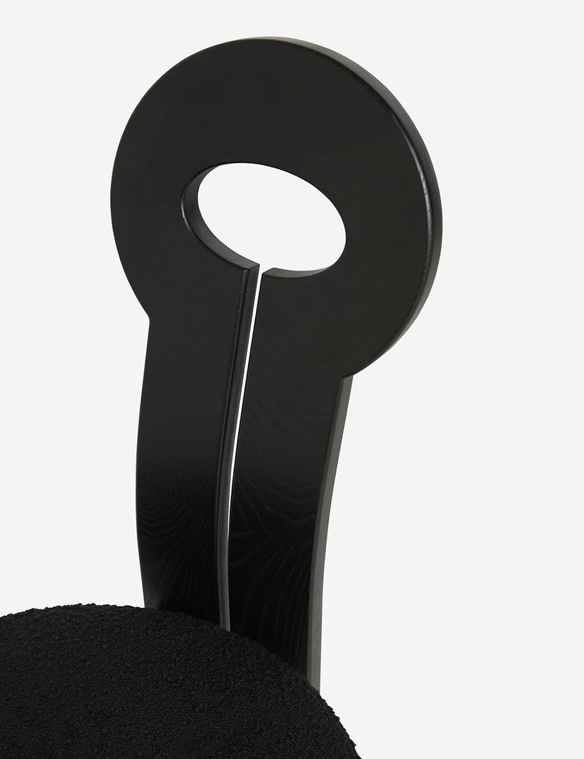 #color::black | Close-up of the eyelet-style back on the Whit black wood sculptural dining chair by sarah sherman samuel